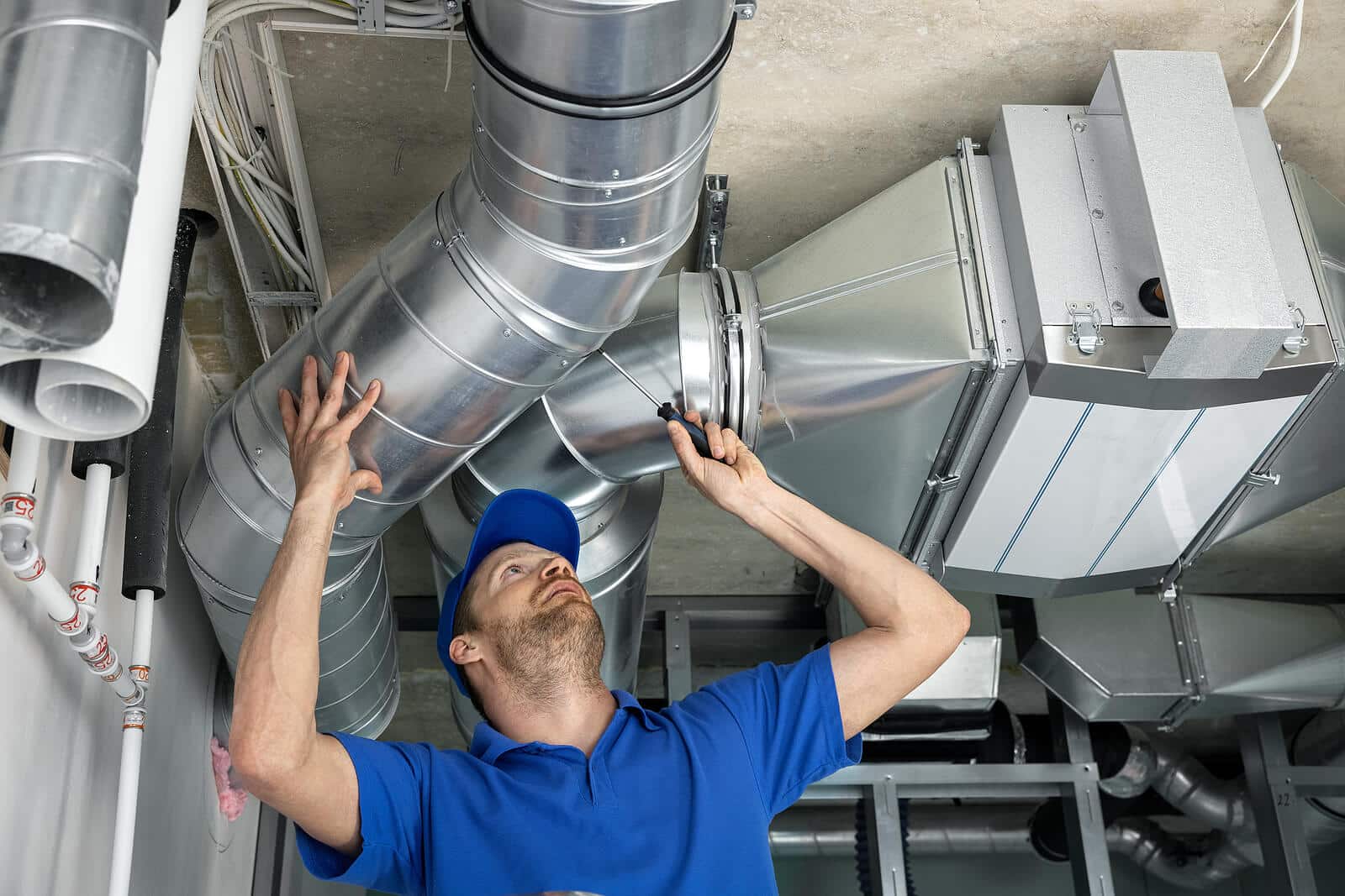 HVAC technician inspecting and repairing air ducts in Arcadia