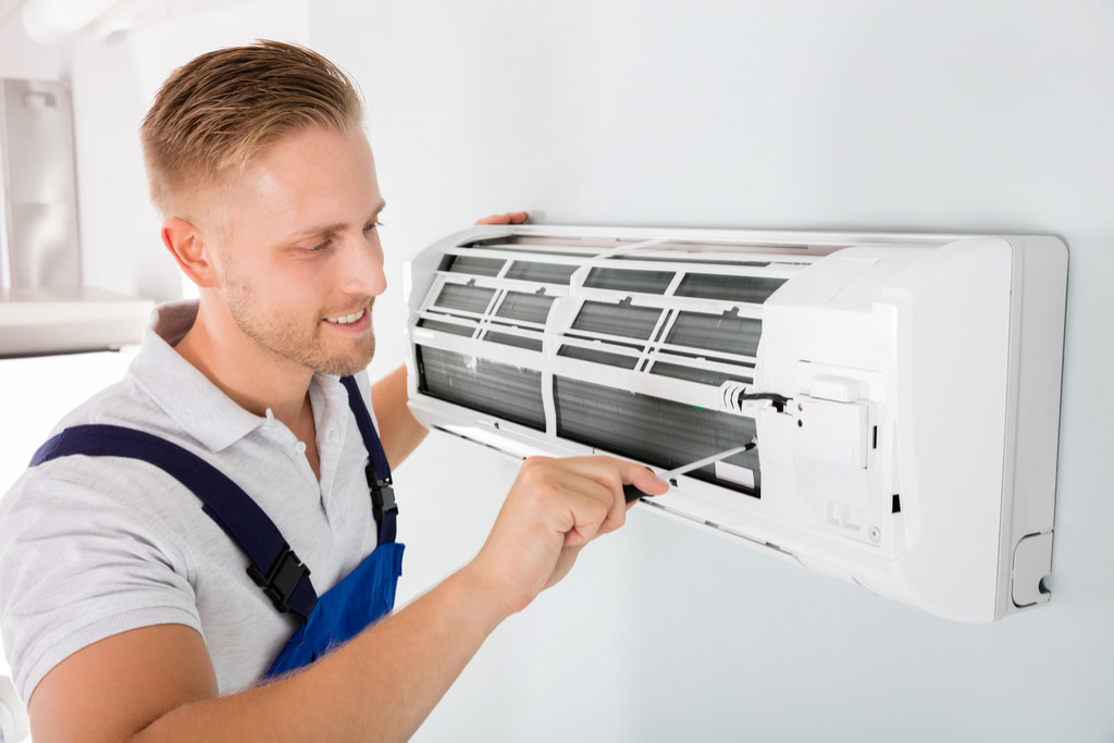 HVAC technician maintaining a ductless air conditioner in Arcadia