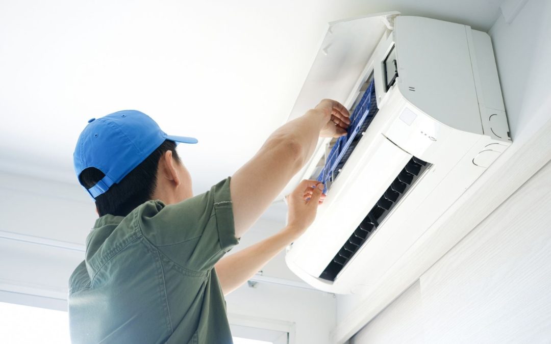 HVAC technician servicing a ductless mini split in Arcadia