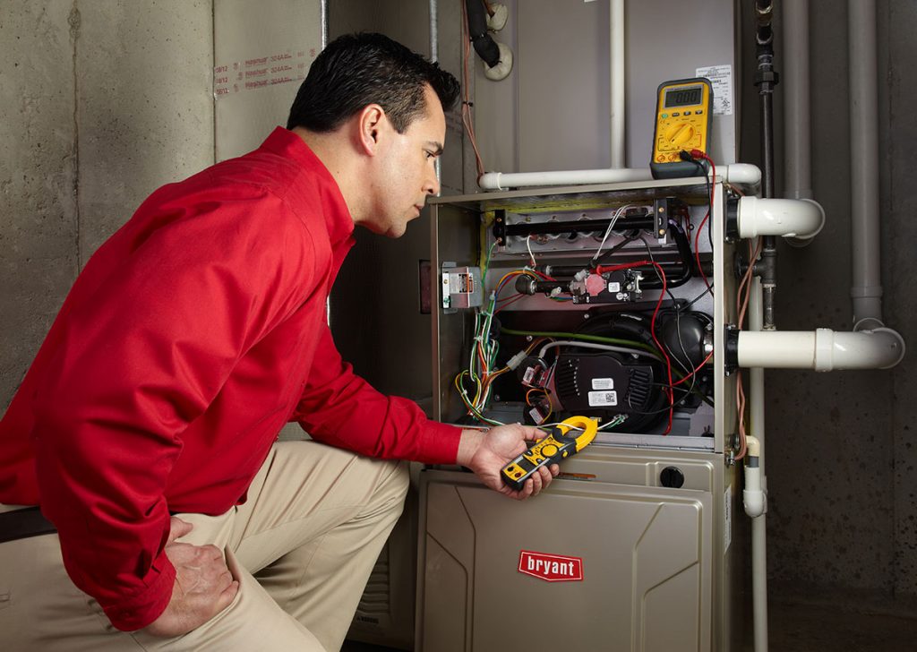 Heating technician diagnosing a furnace repair in Arcadia