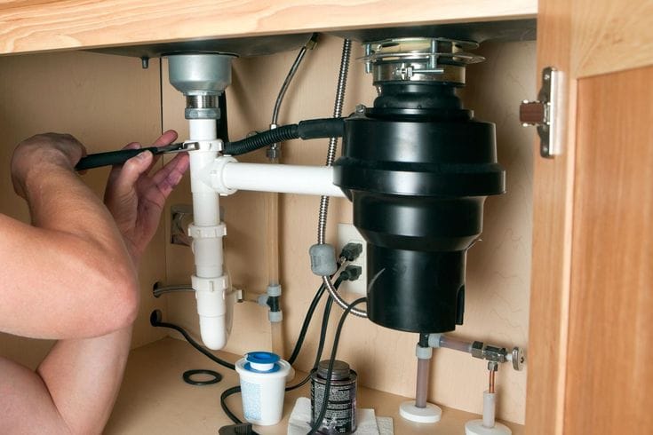 Plumber repairing a garbage disposal in Arcadia