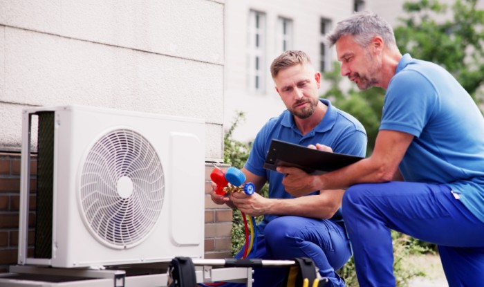 HVAC technicians installing an outdoor air conditioning unit in Arcadia