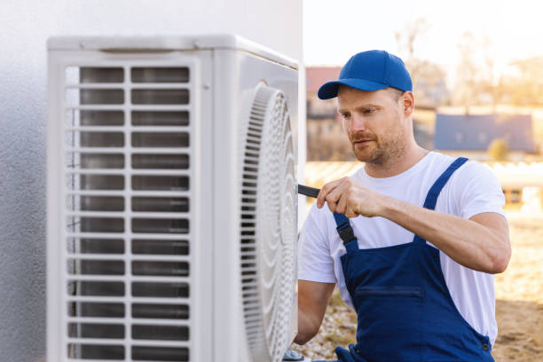 HVAC technician servicing an outdoor air conditioner in Arcadia
